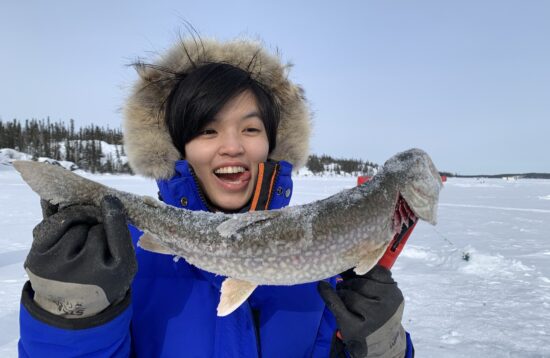 Guests enjoying ice fishing on frozen lake in Yellowknife with North Star Adventures