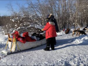 wonderful guests enjoying fun traditional dogsled tour in Yellowknife with North Star Adventures